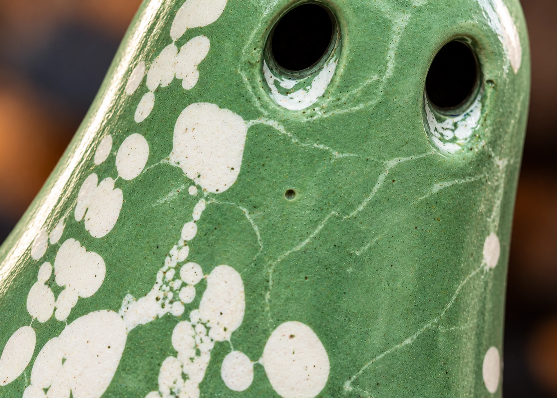 Close-up of Fortuna Light Haunt showing its green finish, white markings and subtle handmade surface texture