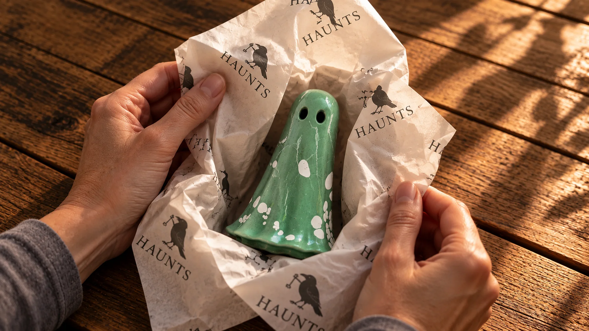 Fortuna Haunt being unwrapped from branded paper as a meaningful handmade gift