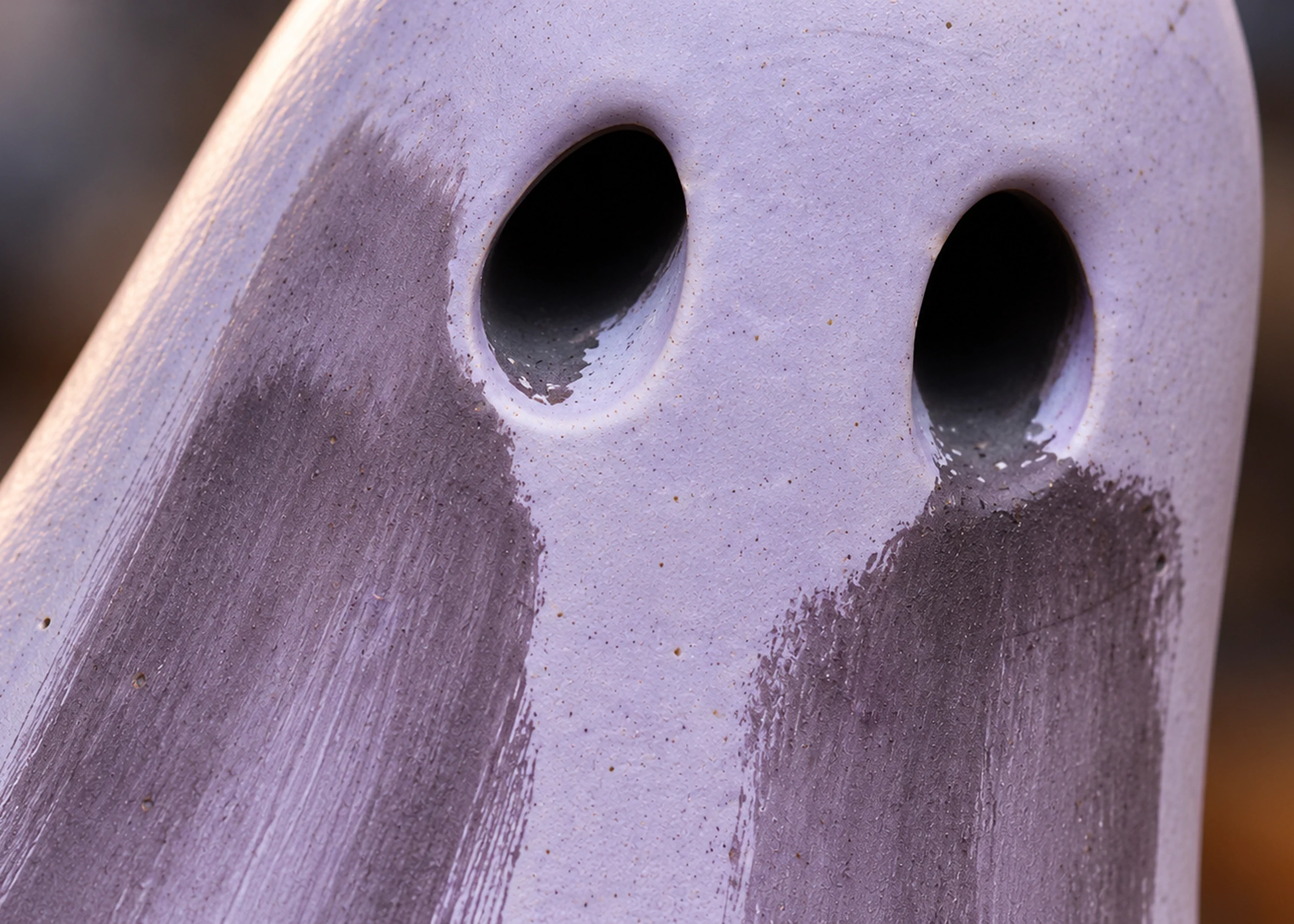 Close-up of Requiem Shadow Haunt showing its pale lavender finish, muted purple brushwork and handmade surface texture